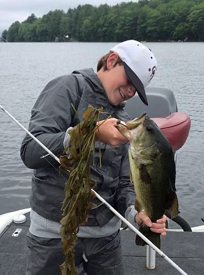 Undeterred by the rain, Andrew Padgett of North Yarmouth, Maine, hooked this large mouth bass on Great Pond.