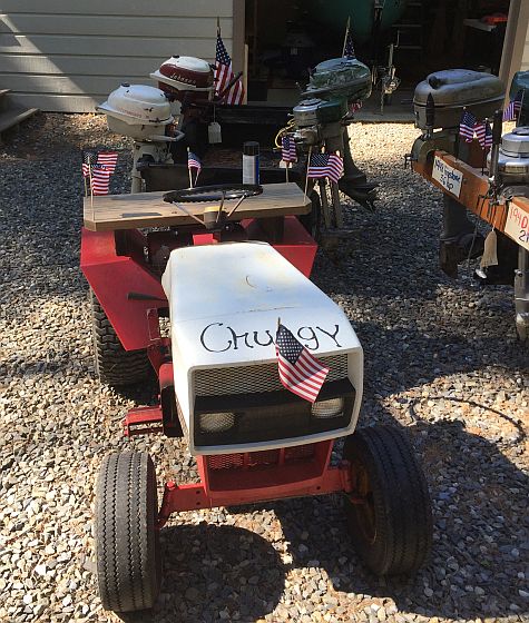 Old outboard motors, some from auctions, being readied for last year's Fourth of July parade.