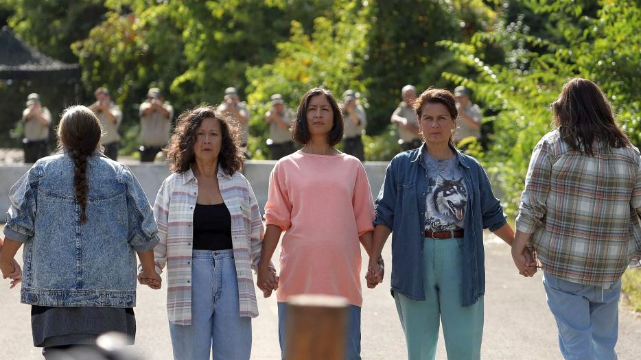 Mohawk women stand between a Mohawk barricade and a police barricade to try to diffuse a tense situation in Beans.