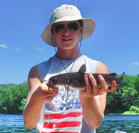 Jesse Stevens of Chapin, SC holds a white catfish he caught in the Kennebec River.