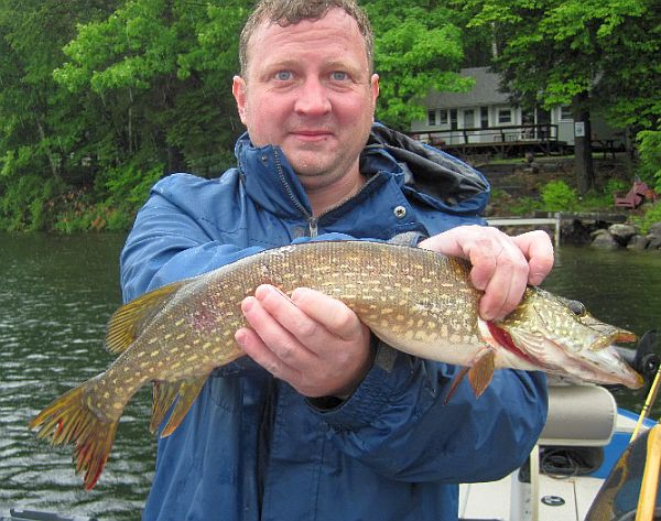 Pete Kallin's son Rob with the pike caught on a rainy Fourth of July.