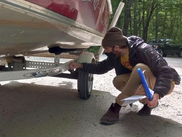 Courtesy Boat Inspector Jarvin DeHaven inspects a boat.