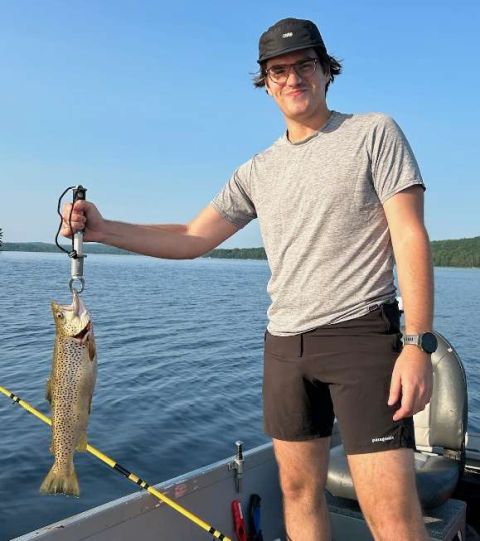 Tim Kowalsky holding a brown trout he caught.