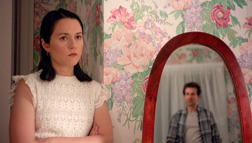 Arabella Oz stars as Mallory in Mallory’s Ghost (2026). She also co-write and co-directed the film. Reflected in the mirror is co-director and co-star Nick Canellakis.
