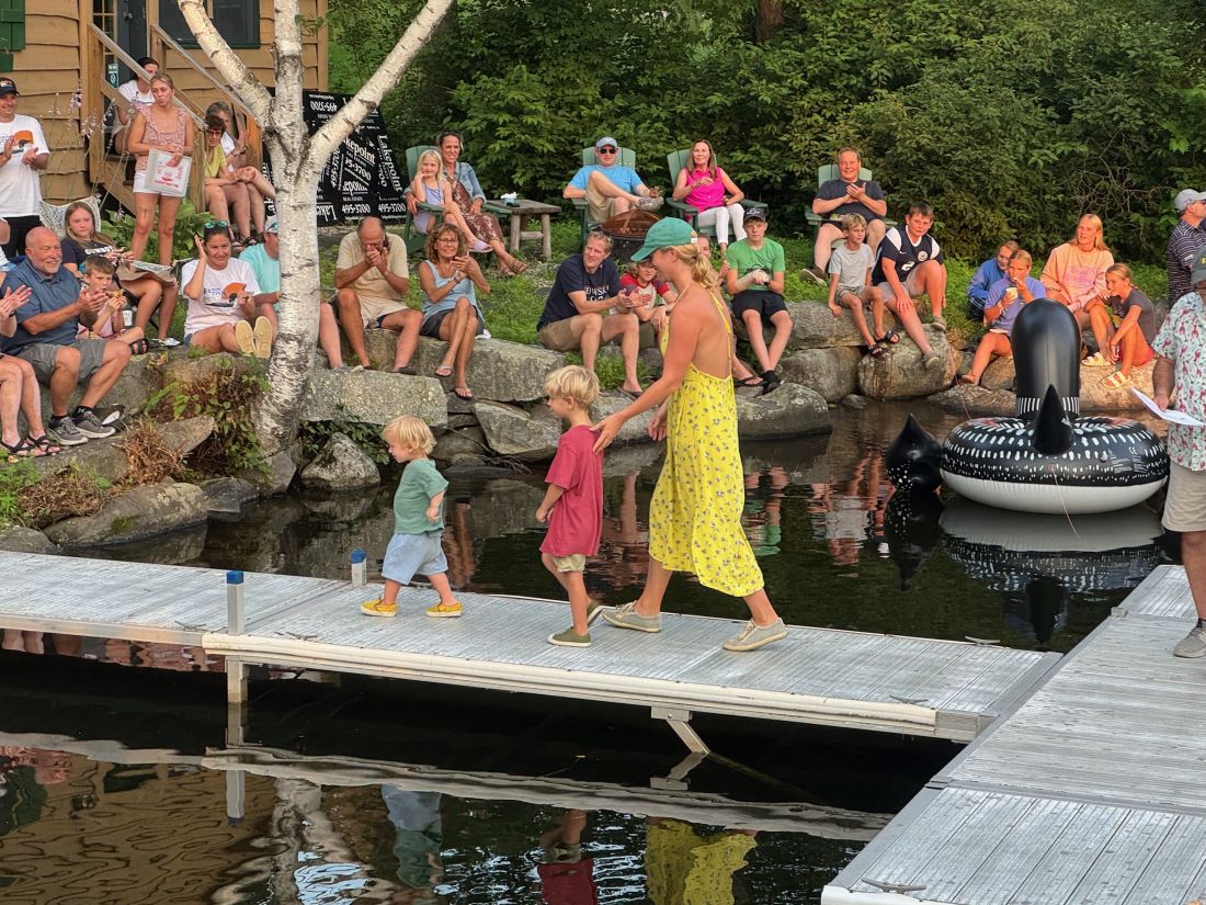 Two little loon callers leave the dock.