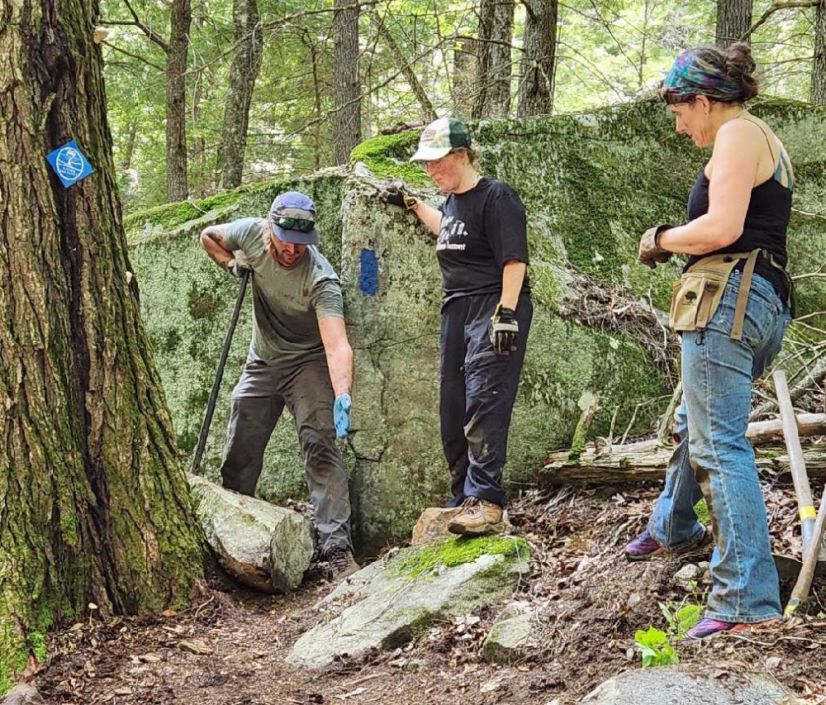 Dan, Sally, and Beth work on a steep hillside on the Lambert Trail, which is part of the Quill Hill Trail System.